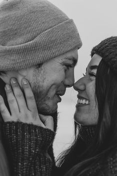 black and white photograph of a man and woman smiling at each other with their heads close to one another