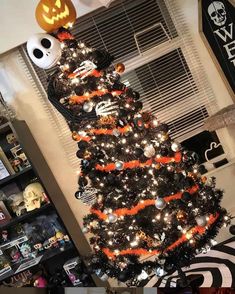 a halloween tree decorated with black and orange decorations