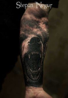 a man's arm with a bear on it and the words stephen neugr written