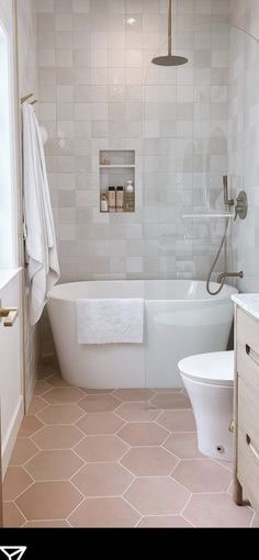 a bathroom with a tub, toilet and sink