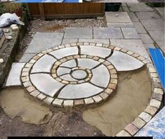 two pictures showing the process of making a circular stone garden path with bricks and pavers