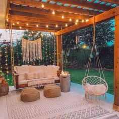 an outdoor living area with furniture and string lights