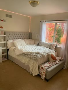 a bedroom with a large bed and window