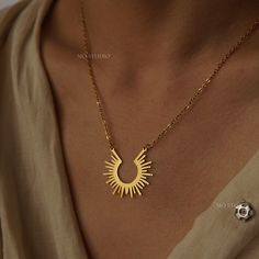 🏷 [DESCRIPTION] This elegant gold sunburst crescent necklace features a modern minimalist design, perfect for adding a touch of sophistication to any outfit. The delicate gold chain complements the striking sunburst pendant, making it a versatile piece for both casual and formal occasions.   - - - - - - - - - - - - - - - - - - - - - - - - 💎[MATERIAL & MEASUREMENT]  - 1 piece - 14K Gold plated over stainless steel - Chain Length: 16in to 18in / 40cm to 45cm - Tarnish-Resistant & hypoallergenic Minimalist Gold Necklace With Sun Design, Necklace Sun, Gold Sunburst, Pendant Making, Crescent Necklace, Sun Necklace, Sun Pendant, Gold Statement Necklace, Necklace Minimalist