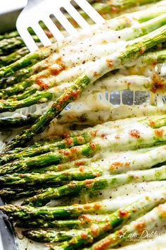 the asparagus are covered with cheese and seasoning