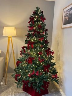 a christmas tree with red bows and lights