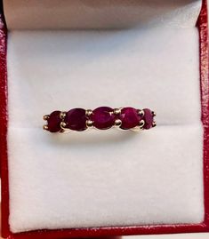 Absolutely Stunning Vintage 14k Yellow Gold Natural Rubies  band Ring 100%  Natural Rubies  Beautiful genuine Ruby 6x4 mm each 5 Rubies                                       2.25 CTW Clarity:                                              VS2 Total ring weight:                        4.1 GR 14K Yellow Gold Ring sizing available Free of Charge For more information regarding this item feel free to reach me so I can accommodate your needs.  Thank you