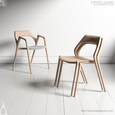 two wooden chairs sitting next to each other on a white floor in front of a wall