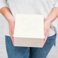 a person holding a white box in their hands