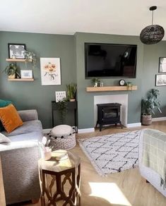 a living room filled with furniture and a flat screen tv mounted on the wall above a fire place