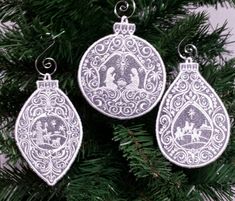 three ornaments hanging from a christmas tree