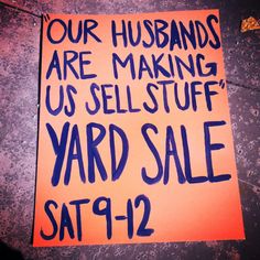 a yard sale sign posted on the side of a building