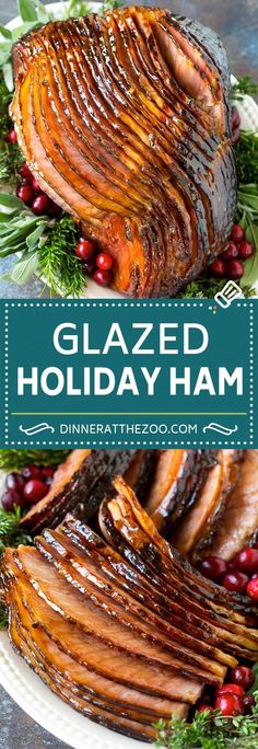 glazed holiday ham on a plate with cranberries and greenery