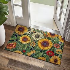 a door mat with sunflowers on it next to a potted plant