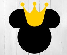 a black and yellow mickey mouse head with a crown on it's head, against a white wood background