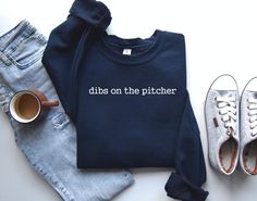 "Pitcher's Girlfriend Shirt, Pitcher Sweat, Baseball Girlfriend Shirt, Baseball Pitcher Shirt, Pitcher's Wife Shirt, Baseball Wife,  PRODUCTION TIME: 1-3 days (Usually 2 days) SHIPPING TIME: 2-5 days (Usually 3 days) PRODUCT DESCRIPTION: Gildan UNISEX Sweatshirt and Hoodie GILDAN Unisex hoodies and Sweatshirts are made of premium quality material. The garment Gildan Heavy Blend fits perfectly and feels soft and comfortable. The colours of vinyl and the garment can be chosen according to your taste. CARE INSTRUCTION: Machine wash: warm (max 40C or 105F); Non-chlorine: bleach as needed; Tumble dry: medium heat; Do not iron; Do not dryclean. We care about: - You, therefore our vinyl was certified by \"REACH\", \" \" Öko-Tex® Standard 100 Class I \". - The Environment, so no animals were hurt Baseball Girlfriend Shirts, Cheer Coach Gifts, Baseball Girlfriend, Airplane Shirt, Dance Mom Shirts, Gifts For Programmers, Nanny Gifts, Cheer Coach, Pilot Shirt