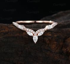 a rose cut diamond ring on top of a piece of wood