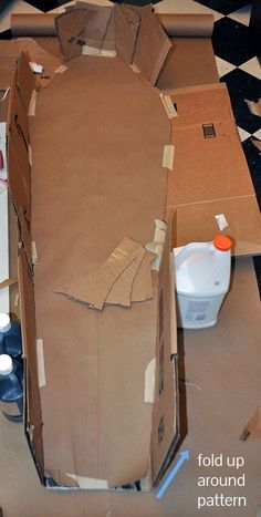 an open cardboard box sitting on top of a black and white checkered floor