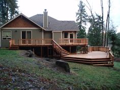 a house with deck and stairs in the front yard