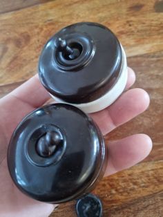 two black and white donuts sitting on top of a wooden table