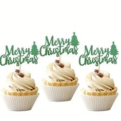 three cupcakes with christmas trees on top and merry christmas sign in the middle