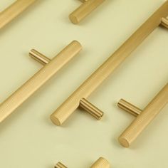 several wooden handles and pulls on a white surface