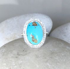 An elegant, OOAK low-profile cabochon Turquoise Ring adorned with Halo White Topaz handcrafted in sterling silver, which makes a striking engagement/promise/statement/December birthstone ring. Wrapped in a branded box ready for gift giving. This ring is a FINAL SALE. (r.egt.40) Ring Info Blue Gemstone Ring, December Birthstone Ring, Boho Turquoise, Elongated Oval, Blue Gemstone Rings, Moonstone Engagement, Moonstone Engagement Ring, Turquoise Boho, Bridal Ring Set