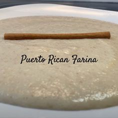 a white plate topped with food and a wooden stick