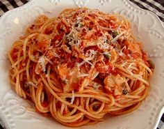 a white plate topped with spaghetti and sauce