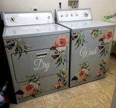 two washers and dryer sitting side by side in a room