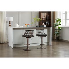 two stools sitting in front of a kitchen counter