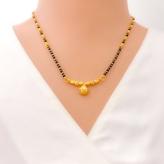 Weighing 11.0 grams, this 22k gold thali mangal sutra embodies classic allure with its timeless design. The black bead accents provide a striking contrast to the yellow gold finish, creating a piece that is both elegant and traditional. The 16-inch necklace length ensures a comfortable fit, while the 0.25-inch drop adds a subtle yet stylish detail. With a secure hook lock, this mangal sutra blends cultural significance with sophisticated charm, making it a perfect symbol of marital unity and tim Mangalsutra Traditional, Wati Mangalsutra, Luxury Traditional Yellow Gold Mangalsutra, Luxury Traditional 22k Gold Mangalsutra, Luxury Black Traditional Mangalsutra, Mangal Sutra, 22k Gold Bangles, 16 Inch Necklace, Lock Style