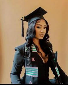 a woman wearing a graduation cap and gown with her hands on her hips, posing for the camera