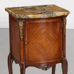 an ornate wooden cabinet with marble top