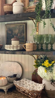 the shelves in this kitchen are filled with dishes and vases full of flowers on them