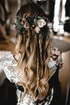 a woman with long hair and flowers in her hair