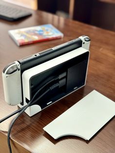 an electronic device sitting on top of a wooden table