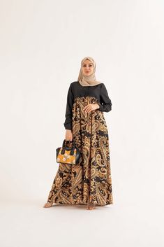 Bring a touch of luxury to your summer wardrobe with the Safa Golden Maxi Dress. Crafted with lightweight fabric that keeps you cool and stylish, it features a gold Paisley pattern for an eye-catching look. With its flattering loose fit body, button front, side zipper, and relaxed fit, you'll be able to flaunt your curves with confidence and privacy. Feel luxurious this summer! The model is wearing a size US6 Model is 70inches / 180cm, and a size US6 The standard length of our dresses is 59 inch Gold Paisley, Fit Body, Gold Dress, Paisley Pattern, Modest Dresses, Summer Wardrobe, Lightweight Fabric, Side Zipper, Breathable Fabric