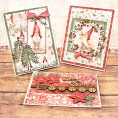 three christmas cards on top of a wooden table