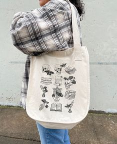 "This canvas tote is perfect for everyday use! It can be used as a reusable shopping bag or even just a standard tote bag for all your essentials! * 100% Certified Organic Cotton * Medium Heavy Canvas * Bag Size 14.50\"h x 12.50\"w * Handle Length: 24.25 \" D E S C R I P T I O N * tote bag, canvas tote bag, tote bag canvas, reusable tote bag, cute tote bag, tote bag aesthetic, womens tote bag, mini tote bag, small canvas tote bag, shoulder bag, shopping bag, market bag, trendy tote bag, produce Everyday Bookish Tote Canvas Bag, Bookish Canvas Tote Bag For Everyday Use, White Bookish Bag For Everyday Use, One Shoulder Backpack, Teacher Tote Bag, Teacher Tote, Bag Aesthetic, Trendy Tote Bags, Produce Bags