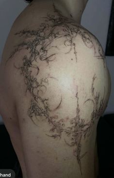 the back of a woman's shoulder with vines on it