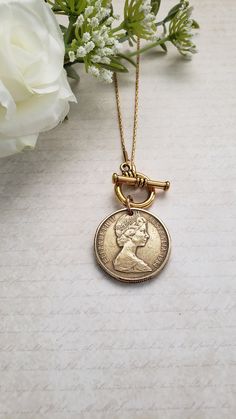 "For your favorite Australian, this necklace will be a treasure! Your choice of a silver-toned Australian 50-cent coin with the image of Queen Elizabeth on one side and an emu and kangaroo on the reverse side or a gold-toned Australian dollar coin with Queen Elizabeth on the front and kangaroos on the reverse side. The coin dangles from either a 16\" or 18\" matching chain with a front toggle closure. Welcome to Recycled Finery!  I repurpose old jewelry, coins, beads, vintage buttons, watch part Vintage Adjustable Coin Necklace, Vintage Charm Coin Necklace With Round Pendant As Gift, Vintage Charm Medallion Coin Necklace As Gift, Medallion Coin Necklace With Vintage Charm As A Gift, Vintage Charm Medallion Coin Necklace For Gift, Vintage Coin Necklaces For Anniversary, Vintage Medallion Coin Necklace As A Gift, Medallion Toggle Necklace With Coin Pendant As Gift, Nickel-free Coin Medallion Necklace Gift