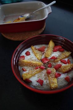 a bowl of yogurt with strawberries and powdered sugar