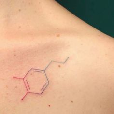 the back of a woman's shoulder with an outline of a chemical structure on it