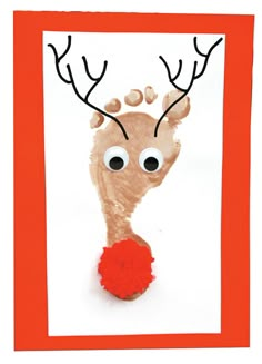 a reindeer handprinted on a card with red pom - pom balls