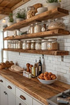 a kitchen with open shelving and lots of food on the counter