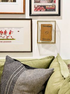 a couch with pillows and pictures on the wall