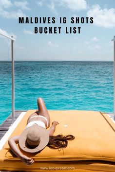 a woman laying on top of a yellow blanket next to the ocean with text overlay that reads maldives i shots bucket list