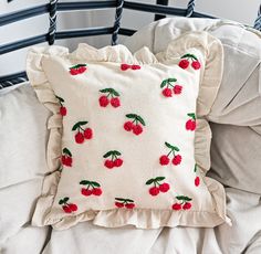 a white pillow with cherries on it