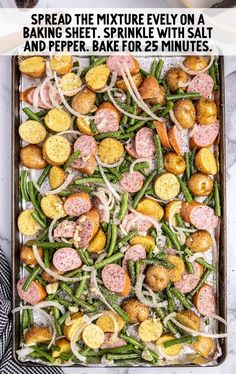 a baking sheet filled with sausage, green beans and potatoes on top of a marble counter